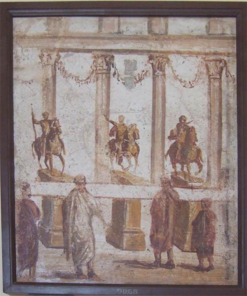 II.4.3 Pompeii. Part of the “Forum Frieze” found in the atrium.  
Forum scene of people reading a banner across the front of the equestrian statues.  
Now in Naples Archaeological Museum. Inventory number 9068.
See Accademici Ercolanesi, 1762. Le Pitture Antiche d’Ercolano: Tome III. (p.227, Tav. 43).
