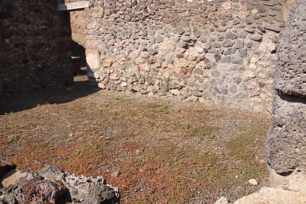 VI.7.15 Pompeii. October 2022. Looking north over wall into large room or triclinium on south side of yard. Photo courtesy of Klaus Heese.