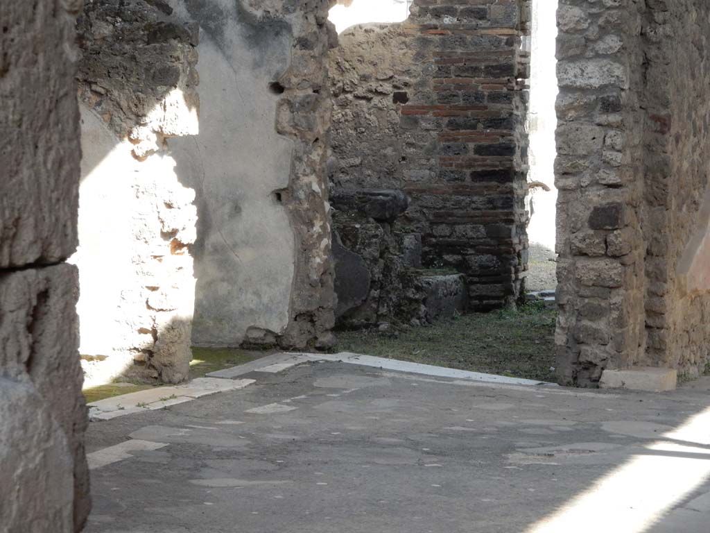 VII.1.40 Pompeii. June 2019. Looking towards south-east corner of atrium. Photo courtesy of Buzz Ferebee.
Left of centre is the doorway into the kitchen area, according to Boyce –
“In the kitchen was found a fragmentary painting with the figures of the Lares along remaining.”
See Boyce G. K., 1937. Corpus of the Lararia of Pompeii. Rome: MAAR 14, (p.61, no.245).



