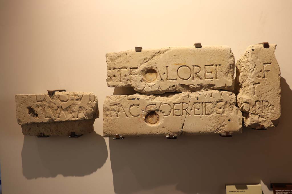 VII.1.40 Pompeii. February 2021. 
Limestone inscription recording the rebuilding of the town walls in about 70BCE after the damages caused by Sulla’s siege, on display in Antiquarium. 
Photo courtesy of Fabien Bièvre-Perrin (CC BY-NC-SA).
According to Epigraphic Database Roma It was found in VII.1.40, House of M. Caesius Blandus (or of Mars and Venus), in pieces 'some of which served for the edge of a door, and others spread on the floor of the peristyle' (aa. 1862-1868).
