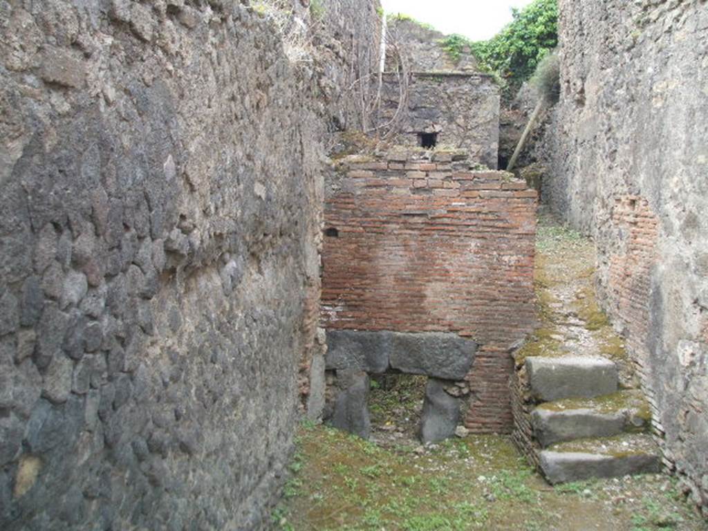 VII.5.7 Pompeii. May 2005. Praefurnium or furnace room between the mens and womens baths. The corridor (24) from the mens changing room (14) was on the left in front of the praefurnium feed. Behind the praefurnium were (in sequence) 
Boiler (28) for hot water (for caldarium). 
Boiler (29) for warm water (for tepidarium).
Large tank (30) for keeping cold water in.