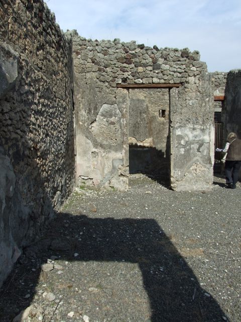 IX.2.18 Pompeii. Pre-1943. Photo by Tatiana Warscher.
Room 1, north wall of the atrium (north-west corner) with traces of IV Style wall decoration. 
On the left is the doorway into Corridor 13, leading to garden area 11.
See Warscher, T. Codex Topographicus Pompeianus, IX.2. (1943), Swedish Institute, Rome. (no.101.), p. 180.
