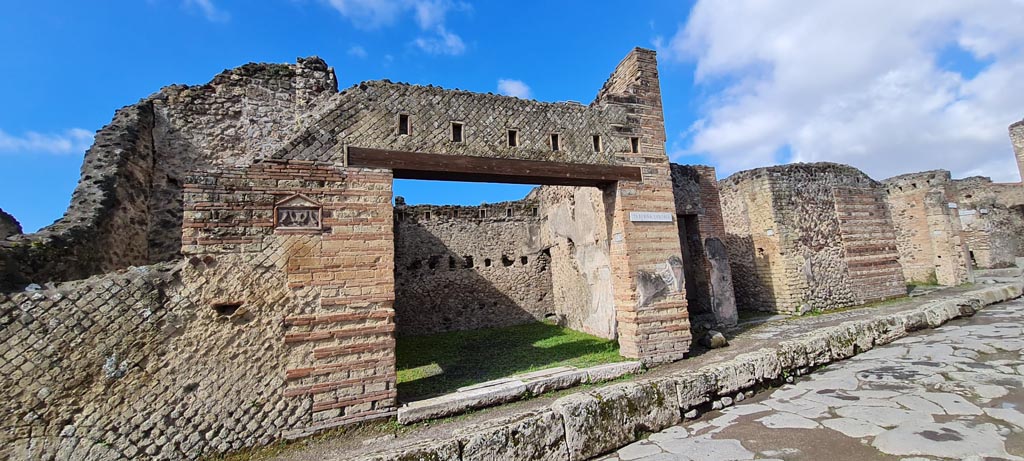Via del Vesuvio, west side, Pompeii. April 2022. 
Looking towards entrance doorway at VI.14.28, in centre. Photo courtesy of Giuseppe Ciaramella.
