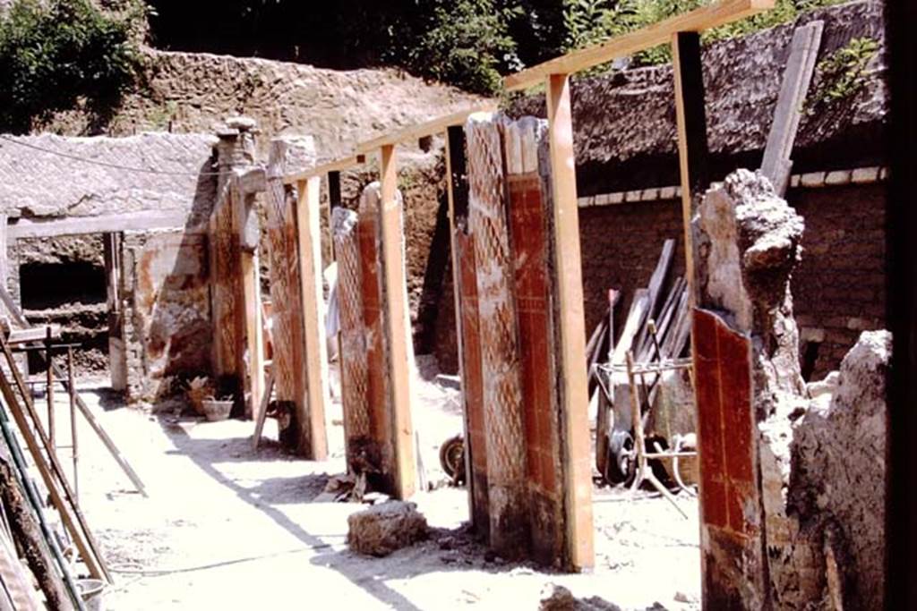 Oplontis, 1973. Looking east along portico 24 in the south-eastern part of the Villa. 
The south-west part of Peristyle 59, with the wheel-barrows, can be seen through the “doorways” between the columns. Photo by Stanley A. Jashemski. 
Source: The Wilhelmina and Stanley A. Jashemski archive in the University of Maryland Library, Special Collections (See collection page) and made available under the Creative Commons Attribution-Non Commercial License v.4. See Licence and use details. J73f0366
