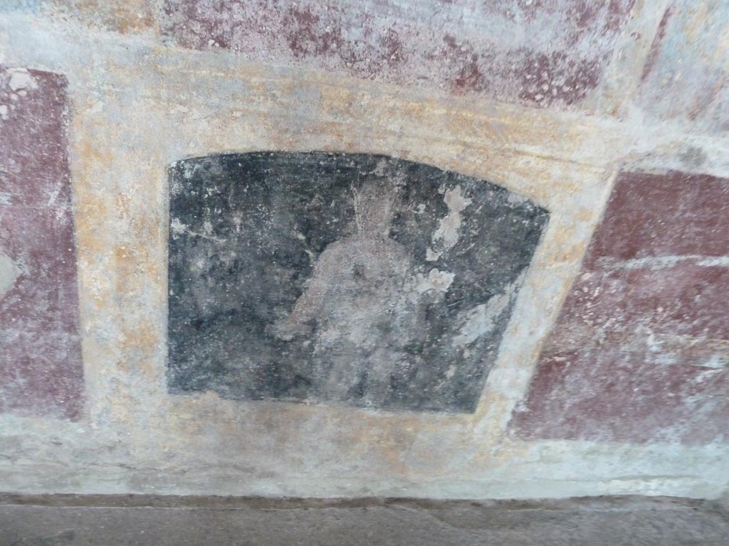 Stabiae, Villa Arianna, September 2015. Room 3, painted figure from zoccolo under mask panel at west end of south wall.