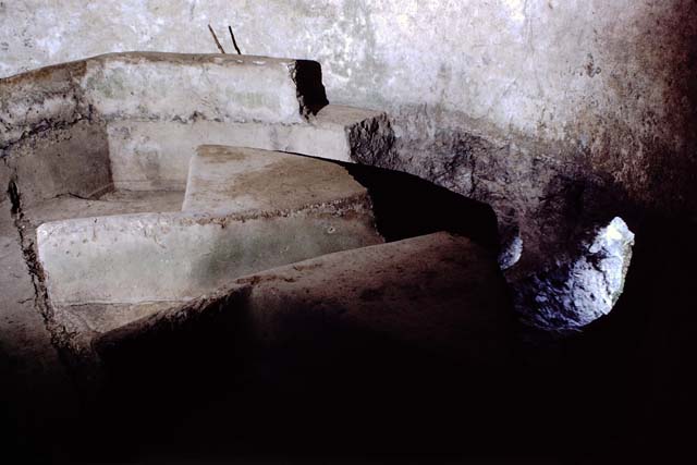 Castellum Aquae Pompeii. July 2010. Basin “B” inside water tower. 
Wall b is at the front, and in the basin are directing walls “G” with dividing walls “m” and “m’ “ at their rear.
The three water outlets could be regulated by a means of shutters which could stop the flow of water if lowered. 
Lead pipes or fistulae fed water to the public fountains and the public baths and to the houses of wealthy citizens.
Some houses had their own suite of baths or large fountains and fountain ornaments in their gardens. 
