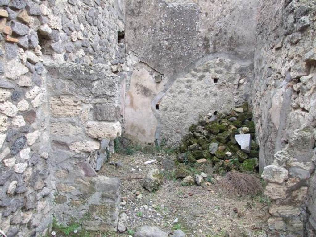 IX.2.16 Pompeii. December 2007. 
Looking south in small storeroom on south-east side of peristyle next to staircase, shown as room “o” in PPM.
On the right of the photo is the doorway leading into a corridor, at the far end of the corridor is the kitchen.
According to Schefold, the location of the lararium was in this room.   
See Schefold, K., 1957. Die Wände Pompejis. Berlin: De Gruyter. (p.241-243)
According to BdI, “from the corridor, a side door gave access to a square room, which has not conserved any of the original decoration other than traces of figures enclosed in red and black compartments and a lararium painting divided into two zones”.
See Bullettino dell’Instituto di Corrispondenza Archeologica (DAIR), 1871, (p. 201)
According to Giacobello –
The painting was seen on the north wall of a storeroom/cupboard (room “o”). 
See Giacobello, F., 2008. Larari Pompeiani: Iconografia e culto dei Lari in ambito domestico. Milano: LED Edizioni, (p.204, no.97).

