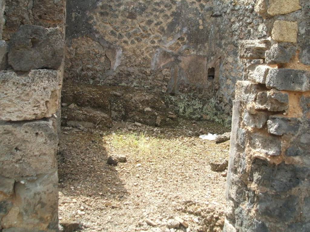 IX.6.3 Pompeii. May 2005. Doorway to kitchen area, “i” looking south.
According to Boyce –
on the east wall (not photographed) was a lararium painting, (h. uncertain as the upper part was damaged when found w.1.32).
An altar stood between the Genius on the right, and the tibicen on the left.
On each side was a Lar with rhyton and situla standing between two shrubs.
In the lower zone were two serpents confronted at an altar furnished with two eggs.
See Boyce G. K., 1937. Corpus of the Lararia of Pompeii. Rome: MAAR 14. (p.86, no.428)
See Sogliano, A., 1879. Le pitture murali campane scoverte negli anni 1867-79. Napoli: (p.12, no. 25) 
According to Giacobello, today the painting has been totally lost.
See Giacobello, F., 2008. Larari Pompeiani: Iconografia e culto dei Lari in ambito domestico. Milano: LED Edizioni. (p.209, no.104)


