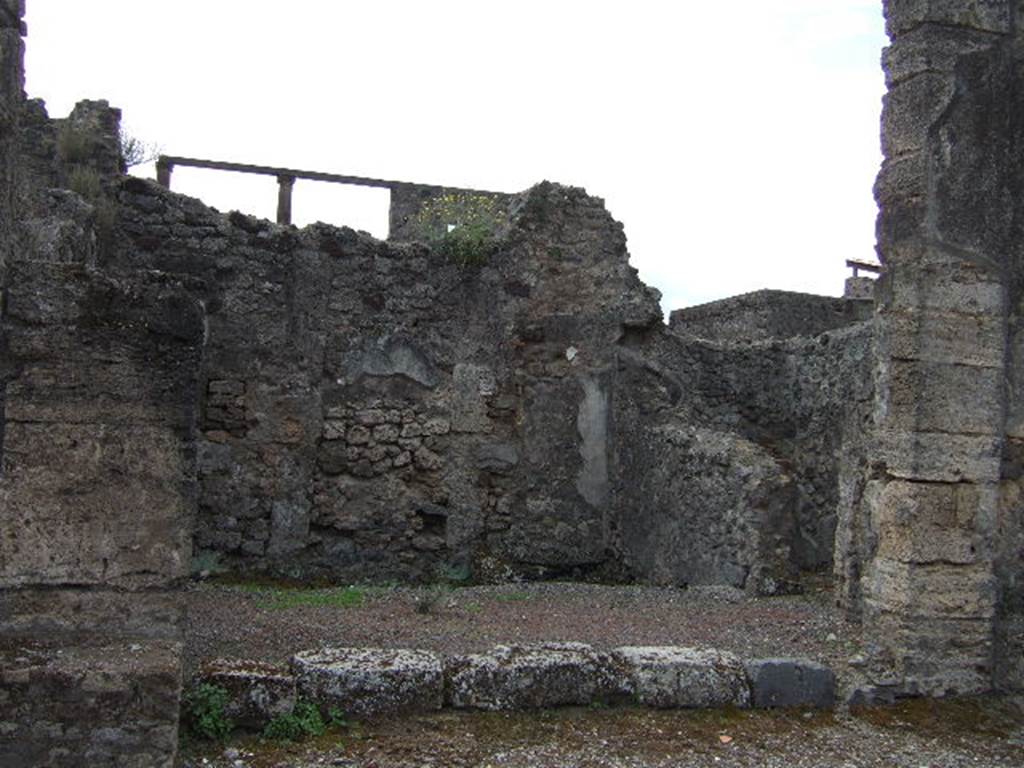 IX.8.4 Pompeii. May 2006. Looking south to entrance doorway of shop. 
According to Della Corte, on the right side of the doorway, was a recommendation –
Ambriaeus (?) cum Vibia rogat    [CIL IV 3746]
See Della Corte, M., 1965.  Case ed Abitanti di Pompei. Napoli: Fausto Fiorentino. (p.137, but note this is 3746 and NOT 3476 as shown in book)
According to Epigraphik-Datenbank Clauss/Slaby (See www.manfredclauss.de)  [CIL IV 3746] read as -  
Aed(ilem)  AVABRIEVS  cum  Vibia  La [3]
rogat  v(iis)  a(edibus)  s(acris)  p(ublicis)  p(rocurandis)  o(ro)  v(os)  f(aciatis)     
According to Cooley, a translation of graffito CIL IV 3820, found here was -
Neighbours beg you to elect Tiberius Claudius Verus (duumvir) with judicial power. Aemilius Celer wrote this.   [CIL IV 3820]
See Cooley, A. and M.G.L., 2004. Pompeii : A Sourcebook. London : Routledge. (p.126) 
According to Della Corte, CIL IV 3820 was found in the vicolo between Insula VIII and IX, and not here. (see IX.9.e)
See Della Corte, M., 1965.  Case ed Abitanti di Pompei. Napoli: Fausto Fiorentino. (p.131)
According to Boyce, on the north wall to the right of the door, were painted the Genius, and below him, a single serpent.
To the left of the door, Mercury was painted between a cock and an omphalos around which a serpent was coiled.
Not.Scavi, 1879, pp.241, 282.
See Boyce G. K., 1937. Corpus of the Lararia of Pompeii. Rome: MAAR 14. (p.90, no.449) 
On the west (right) can be seen a doorway to steps to upper floor, with latrine below.



