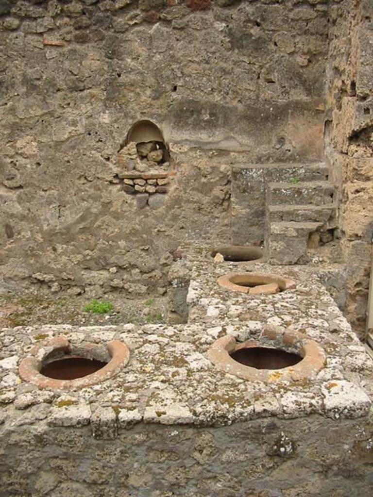 IX.9.1 Pompeii. May 2003. Looking across counter towards the west wall with display shelving and niche. Photo courtesy of Nicolas Monteix.