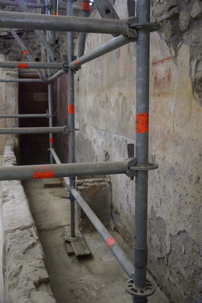 IX.12.6 Pompeii. February 2017. 
Room 6, looking south along west wall towards lararium with altar below. Photo courtesy of Johannes Eber.
