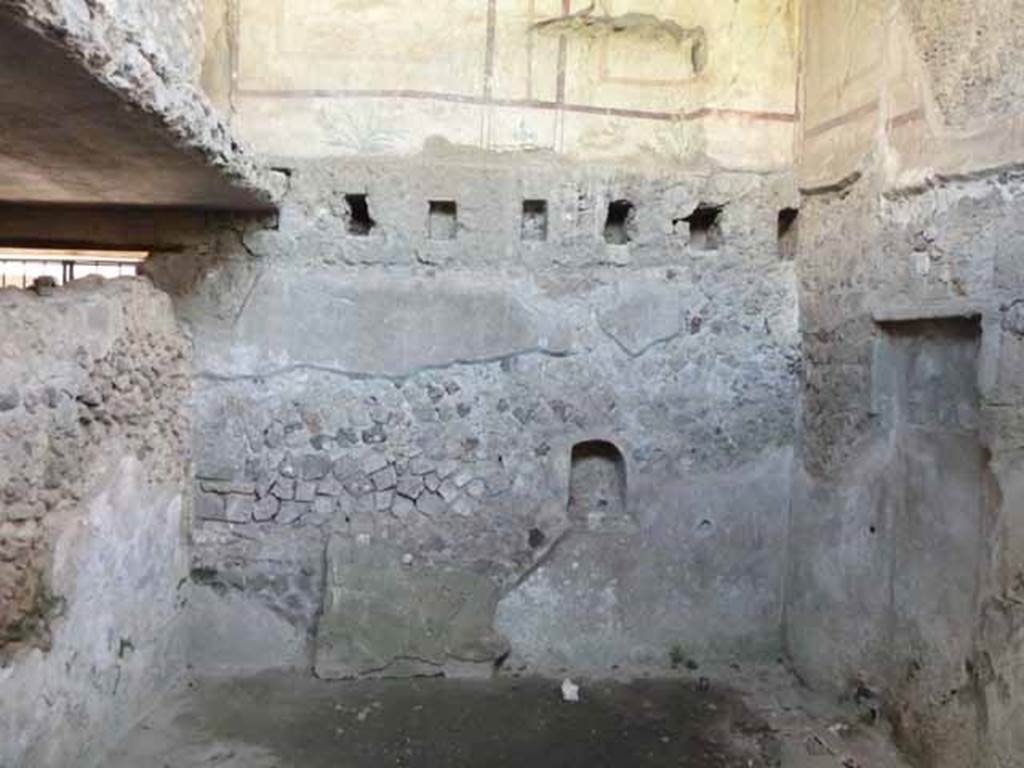 Villa of Mysteries, Pompeii. May 2010. Room 31, rustic room, looking west. According to Boyce, in the west wall was a niche with a projecting shelf elaborately decorated with a frieze in stucco. He assumed it was a Lararium, even though when found it only had a few kitchen jars of coarse materials in it. See Boyce G. K., 1937. Corpus of the Lararia of Pompeii. Rome: MAAR 14. (p. 98) 
