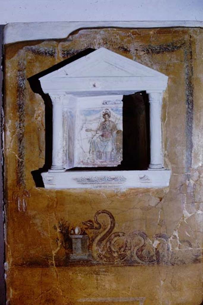 97. Gragnano, Villa rustica in Località Carmiano, Villa A. 1968. 
From dividing pilaster between kitchen room 4 and room 2. 
Lararium in stucco found inserted in a yellow painted wall.
Photo by Stanley A. Jashemski.
Source: The Wilhelmina and Stanley A. Jashemski archive in the University of Maryland Library, Special Collections (See collection page) and made available under the Creative Commons Attribution-Non Commercial License v.4. See Licence and use details.
J68f1875
