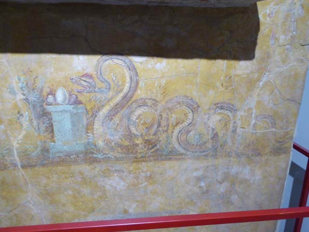 97. Gragnano, Villa rustica in Località Carmiano, Villa A. June 2017. Underneath the aedicula lararium, a painted serpent is moving towards an altar on which was an egg and other offerings. 
Photo courtesy of Michael Binns.
