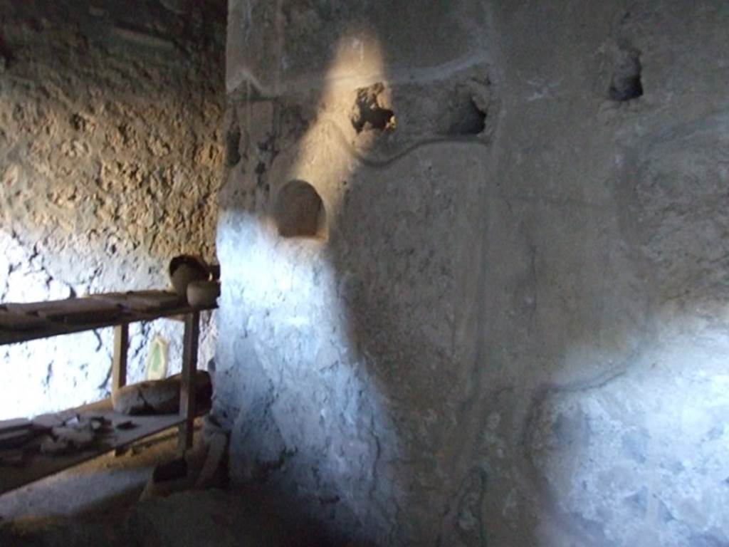 I.10.16 Pompeii. March 2009. Looking south across part of L-shaped kitchen, looking towards south wall with niche.
