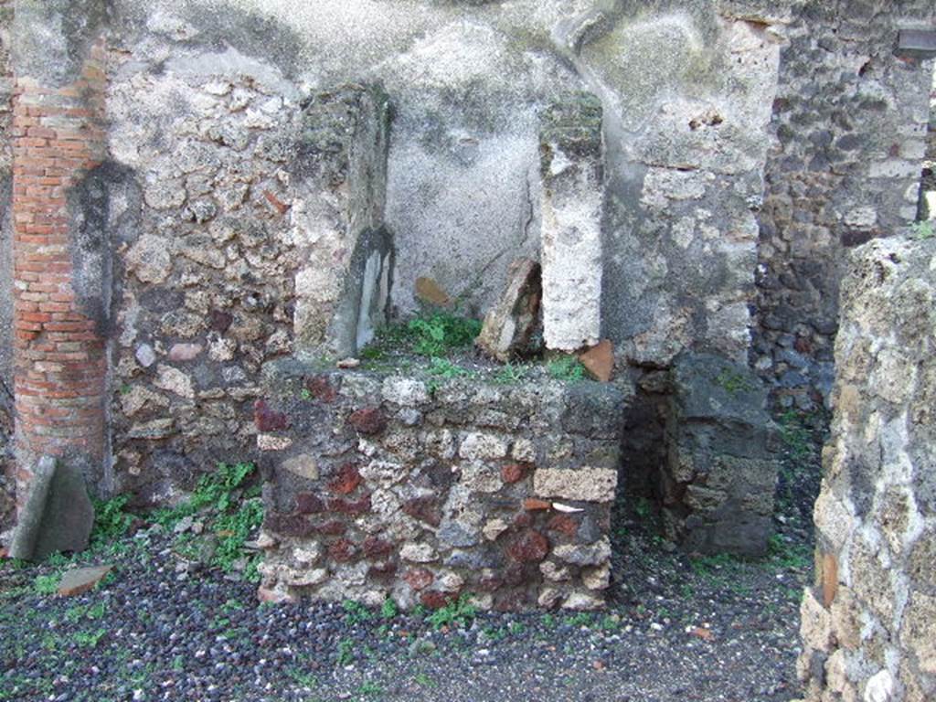 VI.5.14 Pompeii. December 2005.
According to Jashemski, standing against the west wall at the end of the north portico was an aedicula lararium.
See Jashemski, W. F., 1993. The Gardens of Pompeii, Volume II: Appendices. New York: Caratzas. (p.126).
