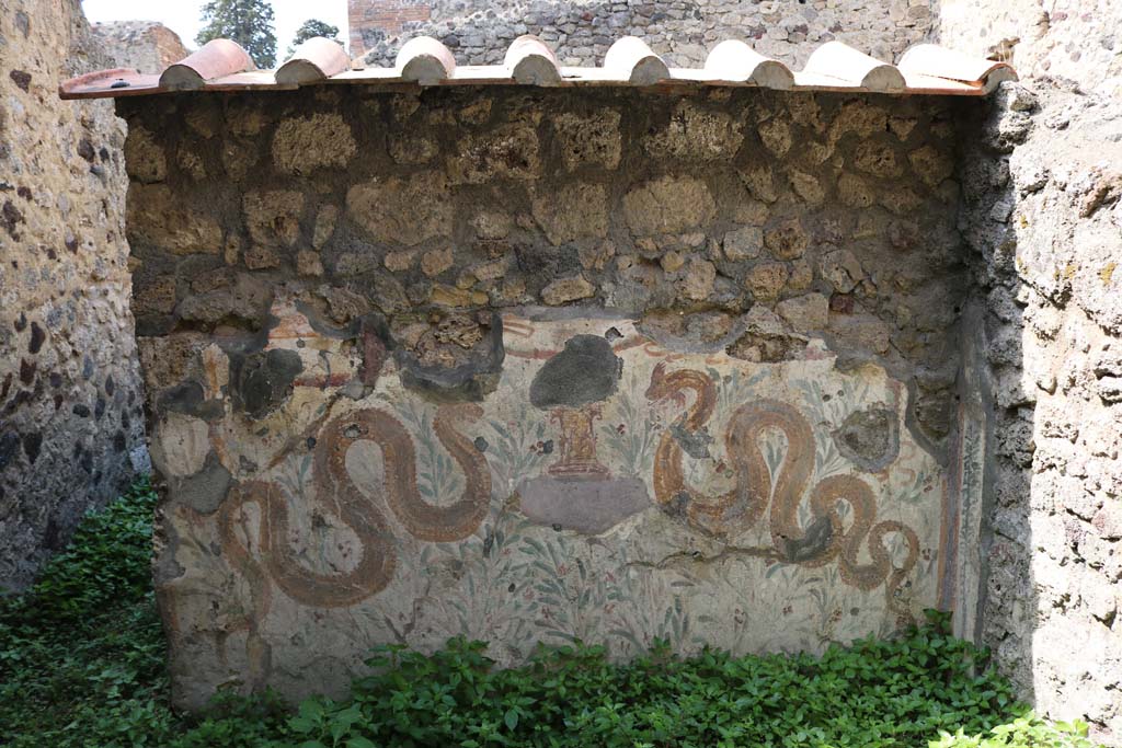 VI.16.40 Pompeii. December 2018. Room F, looking towards west wall with painted lararium. 
Corridor E, leading to bar-room, is on the left. Photo courtesy of Aude Durand.
