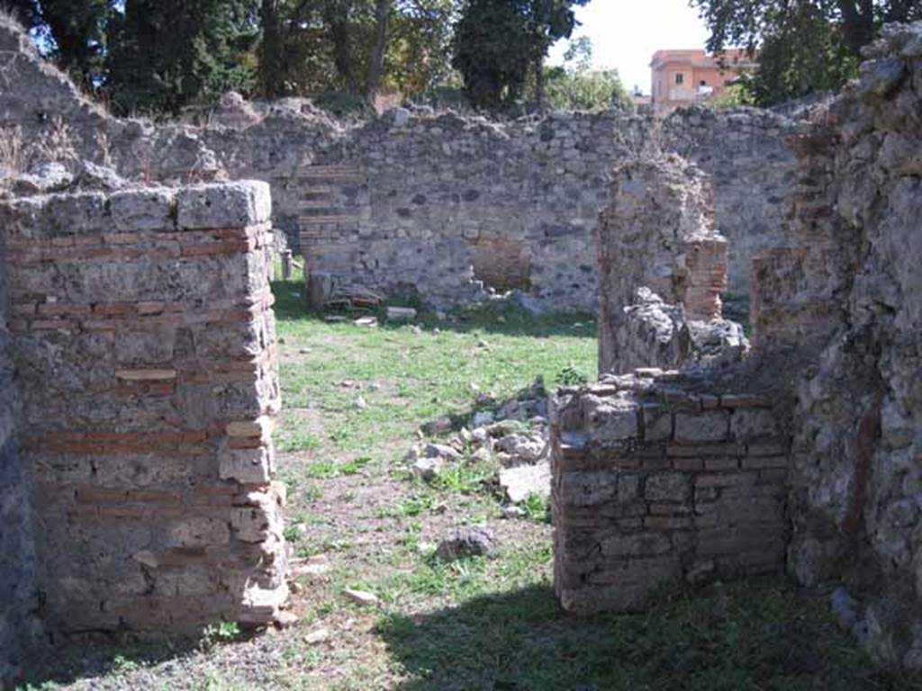 I.1.3 Pompeii. September 2010. Doorway from small room “e”, looking south across yard area “c”. Photo courtesy of Drew Baker.
