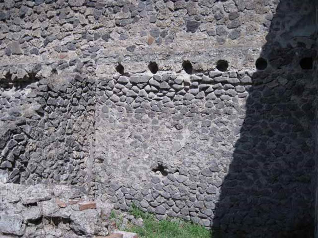 I.1.3 Pompeii. September 2010. East wall of kitchen area, with holes for supports for mezzanine floor. Photo courtesy of Drew Baker.
