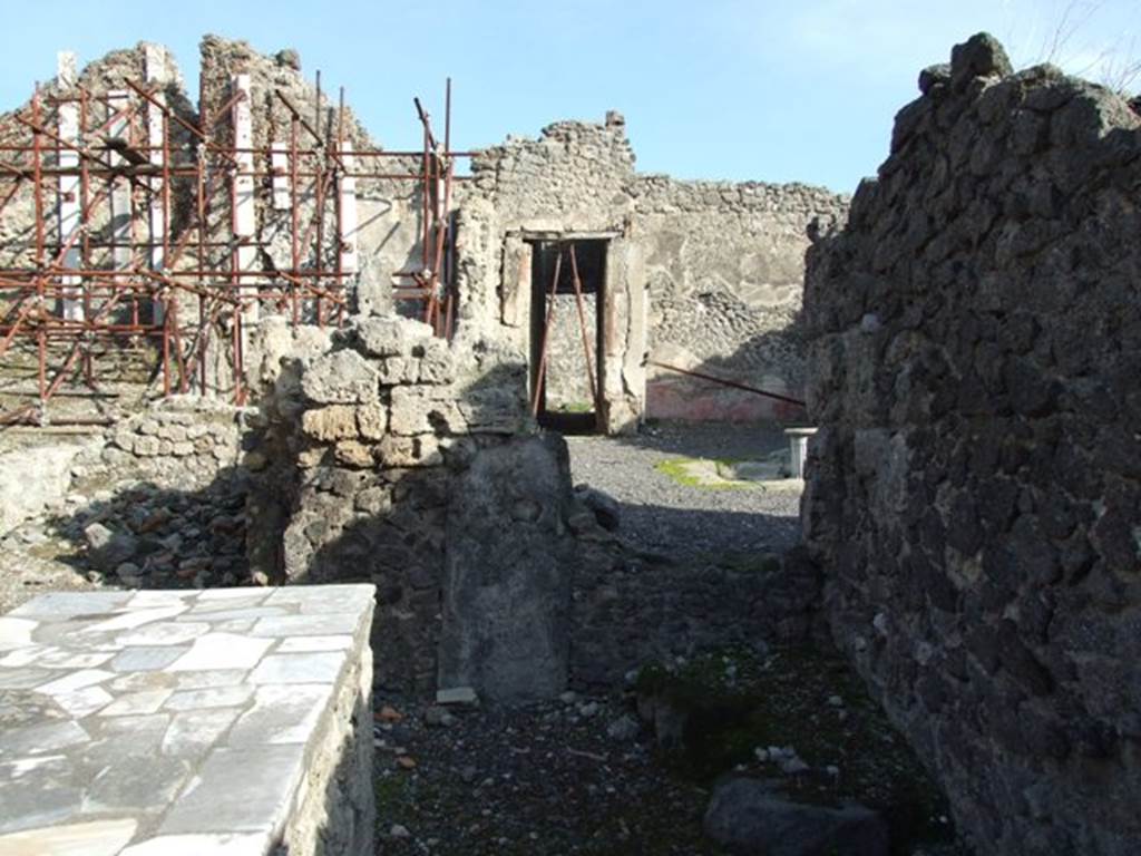 I.2.11 Pompeii. December 2007. Looking east along south wall with stone base in corner.