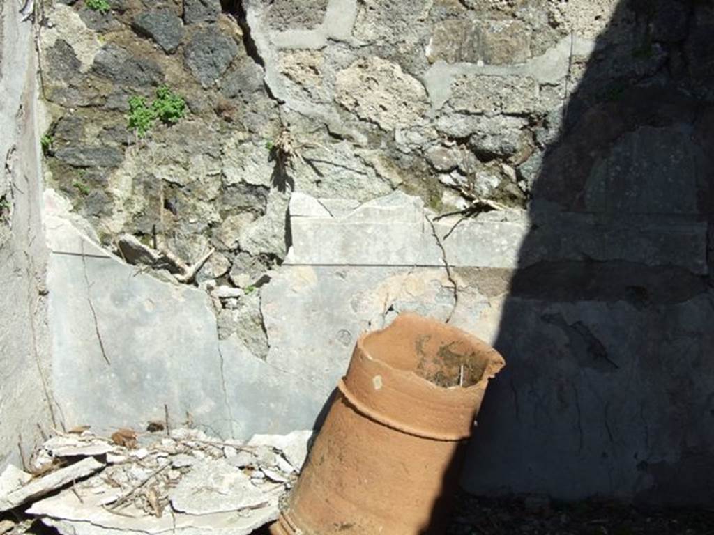 I.2.16 Pompeii. March 2009. Room 5, terracotta puteal and remains of fallen plaster near the east wall of cubiculum.