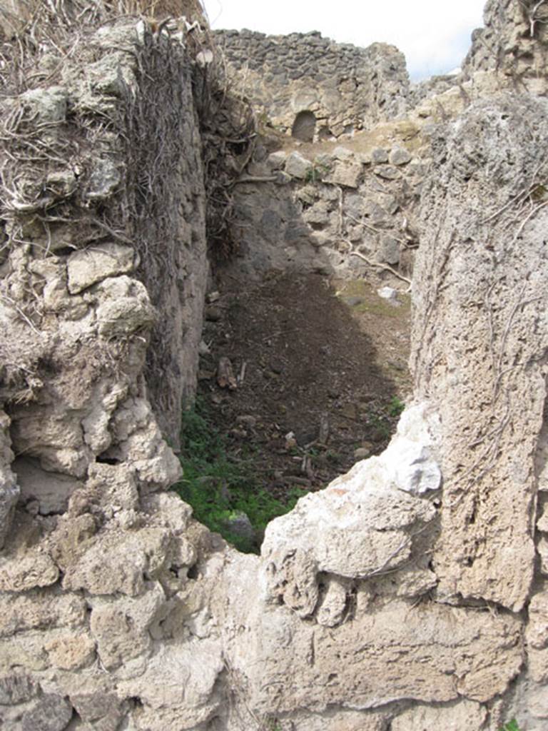 I.3.27 Pompeii. September 2010. Looking north from I.3.3 towards reverse of south-west corner of the above room.  Drew Baker says  the photo was taken to compare form of the aperture. 
The eastern side appears to have a tufa framing member and the base at least a partial threshold however there is no corresponding part on the western side which I would expect. However there is a wall there so it may not have been necessary but as there is what appears to be original fill either this is a door which was blocked up at some point or it is a feature of construction (opus africanum perhaps). 
Photo courtesy of Drew Baker.
