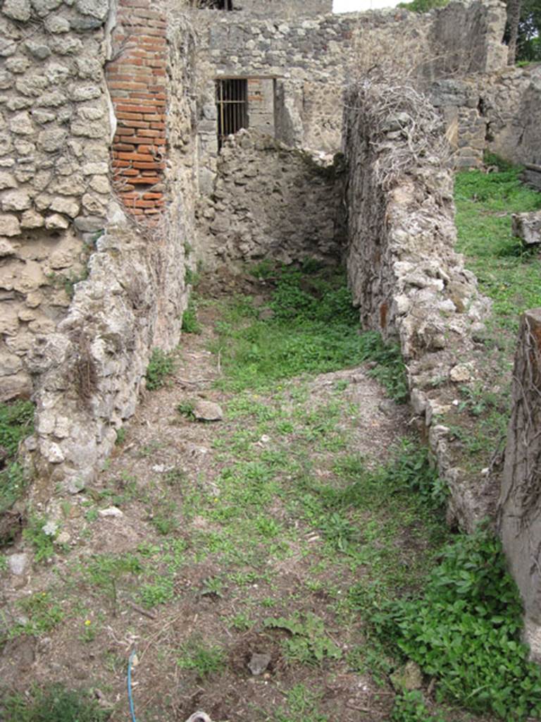 I.3.30 Pompeii. September 2010. Room 9, looking east along corridor leading to blocked doorway into I.3.29, in south-east corner of peristyle. Photo courtesy of Drew Baker.