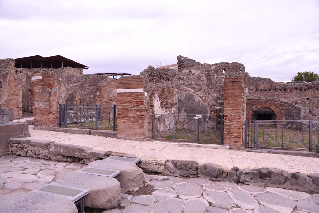 I.4.15, on left, I.4.14, in centre, and I.4.13, on right, Pompeii. October 2019. 
Looking towards east side of Via Stabiana at Holconius crossroads.       
Foto Tobias Busen, ERC Grant 681269 DCOR.
