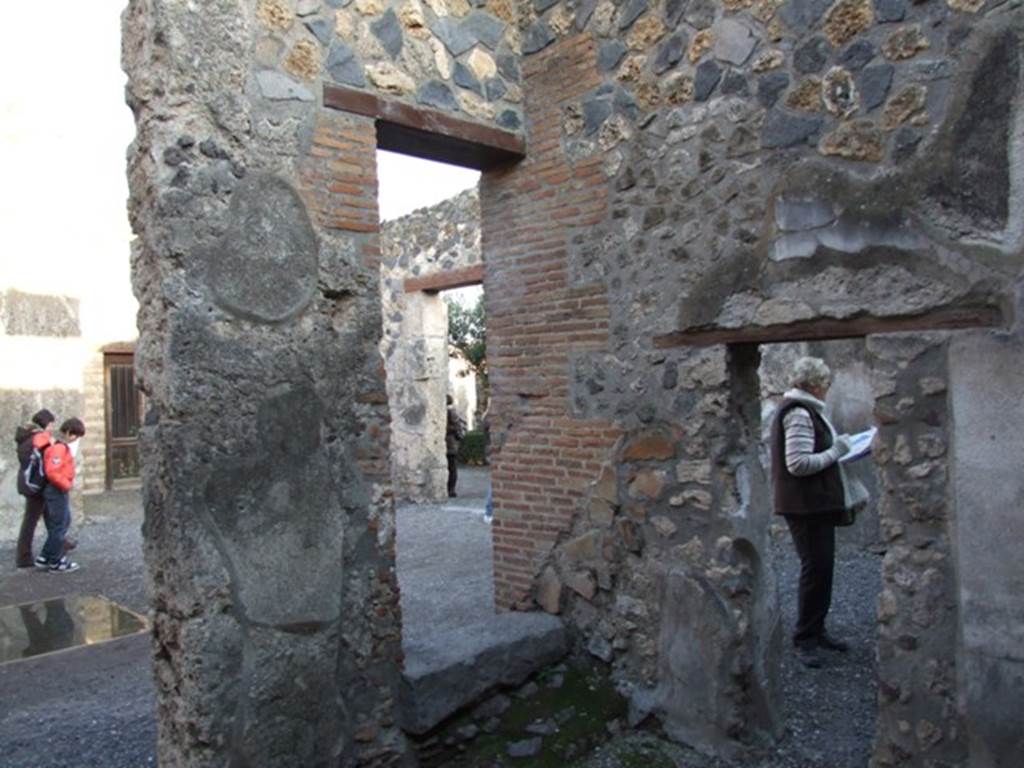 I.4.25 Pompeii. December 2007. 
Room 50, room on west side of atrium with three doorways, south-east corner showing three doorways.
