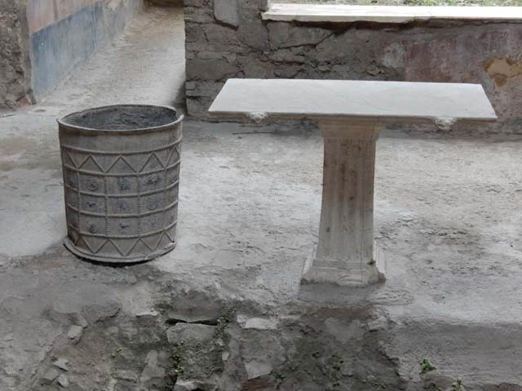 I.7.3 Pompeii. May 2017. Looking towards south side of impluvium, with lead bucket and table.  Photo courtesy of Buzz Ferebee.

