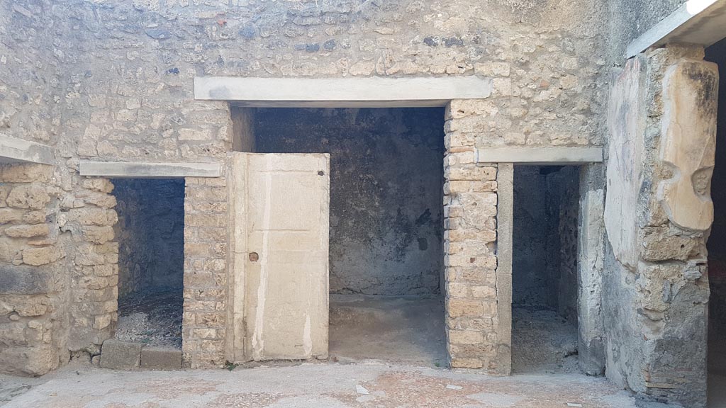 I.7.19 Pompeii. August 2023. Doorways to rooms on north side of atrium. Photo courtesy of Maribel Velasco.

