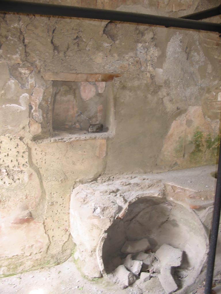 I.8.15 Pompeii. May 2003. 
Looking towards east wall with niche, and broken dolium set in counter below. Photo courtesy of Nicolas Monteix.
