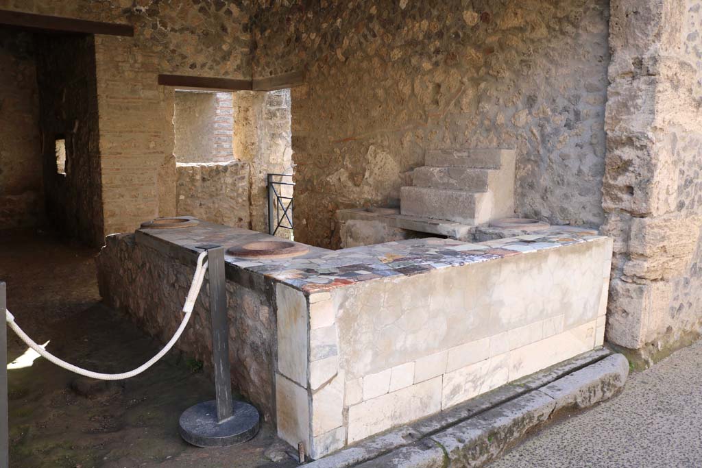 I.9.4 Pompeii. December 2018. Looking south-west across marble topped counter towards west wall. Photo courtesy of Aude Durand.

