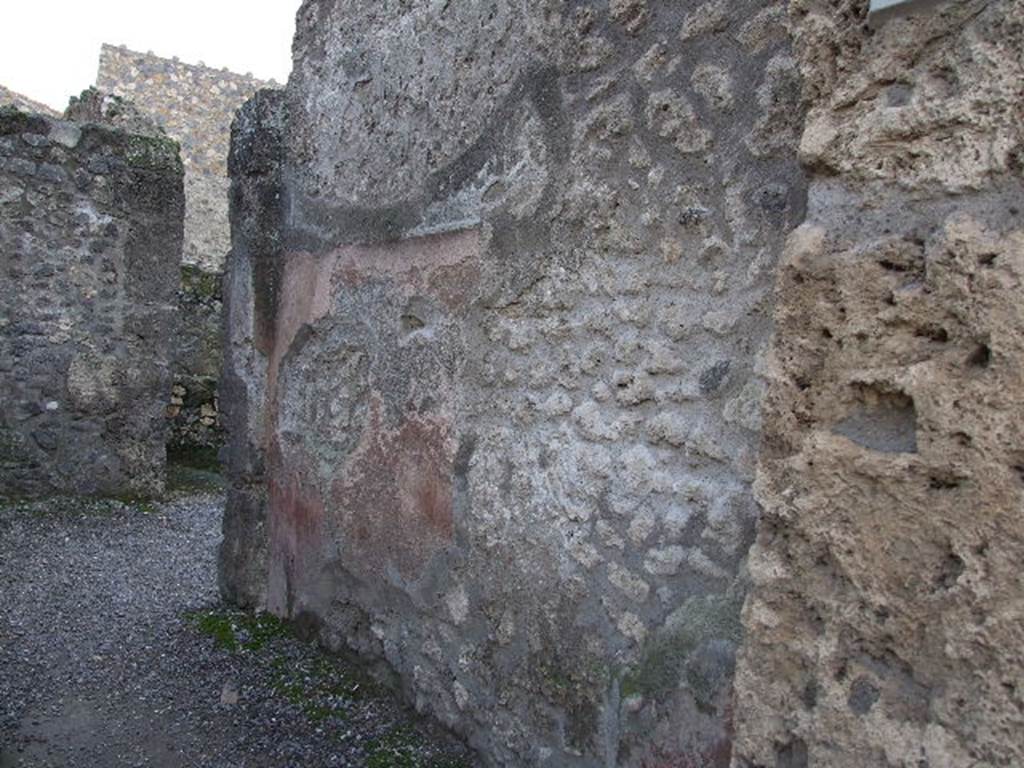 I.10.2 Pompeii. December 2006. West wall of caupona, and site of stairs to upper floor.  According to Della Corte, found to the right of the entrance in very small writing was a set of questions and answers between two rivals in love. Their names were Severus and Successus.  [CIL IV 8259-58] See Della Corte, M., 1965.  Case ed Abitanti di Pompei. Napoli: Fausto Fiorentino. (p.292)
According to Epigraphik-Datenbank Clauss/Slaby (See www.manfredclauss.de), these read as –
Successus textor amat coponiaes ancilla(m) 
nomine Hiredem quae quidem illum 
non curat sed illa com(m)iseretur 
scribit rivalis   vale 
invidiose quia rumper<i=E>s se<c=D>are noli formonsiorem 
/ 
et qui est homo prav<i=E>ssimus et bellus           [CIL IV 8259]
Dixi scripsi amas Hiredem 
quae te non curat SIX() Successo 
ut su[p]ra(t) [3]s[3] 
Severus                                                                           [CIL IV 8258]
According to Cooley, this the love story of Successus, Severus and Iris played out on the walls of the bar. [CIL IV 8258, 8259]
There are 3 messages, the first and third by Severus, the second is the reply of Successus.  These translate as -
(Severus)  -  “Successus, a  weaver, loves the innkeeper’s slave girl named Iris, She, however, does not love him.  Still he begs her to have pity on him. His rival wrote this.  Goodbye” 
(Answer by Successus)  - “Envious one, why do you get in the way. 
 Submit to a handsomer man and one who is being treated very wrongly and good looking” 
(Answer by Severus) -  “I have spoken. I have written all there is to say. You love Iris, but she does not love you”.
See Cooley, A. and M.G.L., 2004. Pompeii : A Sourcebook. London : Routledge. (p.77-78) 

  