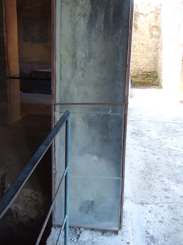 I.10.4 Pompeii. May 2006. Carbonised wood on door frame of room 18.