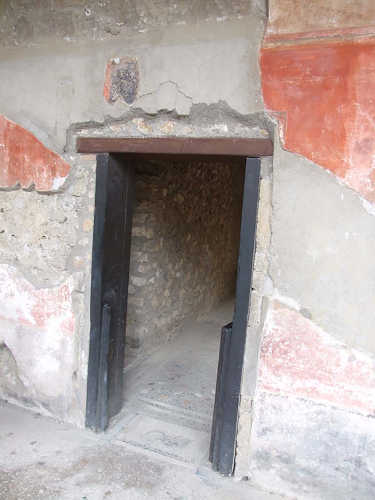 I.10.4 Pompeii. December 2006. Doorway to room 46, the baths area, in the west wall of portico.
The baths area has an atrium, a tepidarium (warm room) and a caldarium (hot room). All have mosaic floors.
