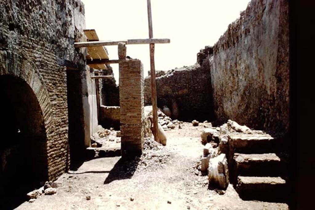 I.12.2 and I.12.1 Pompeii. 1961. Room 11, steps to upper floor, against west wall. 
Looking south towards room 12. Photo by Stanley A. Jashemski.
Source: The Wilhelmina and Stanley A. Jashemski archive in the University of Maryland Library, Special Collections (See collection page) and made available under the Creative Commons Attribution-Non Commercial License v.4. See Licence and use details.
J61f0246
