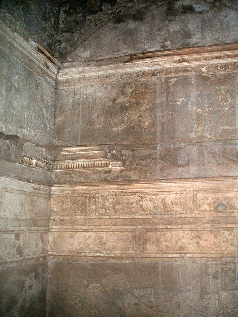 I.15.3 Pompeii. December 2004. 
Room 6 in north-west corner, detail of stucco on upper north and west walls.
