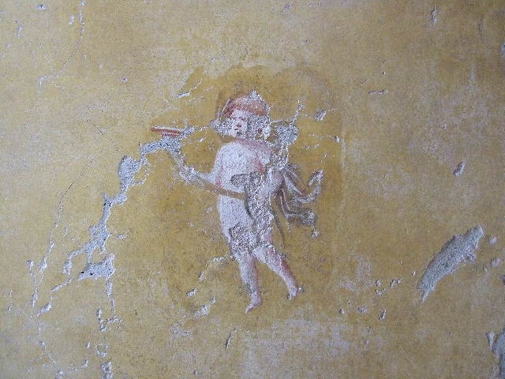 I.16.4 Pompeii. December 2006. Detail of wall painting of cupid from west wall of cubiculum.