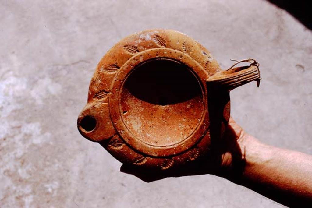 I.20.3 Pompeii. 1972. Example of type of lamp found here. Photo by Stanley A. Jashemski. 
Source: The Wilhelmina and Stanley A. Jashemski archive in the University of Maryland Library, Special Collections (See collection page) and made available under the Creative Commons Attribution-Non Commercial License v.4. See Licence and use details. J72f0114
