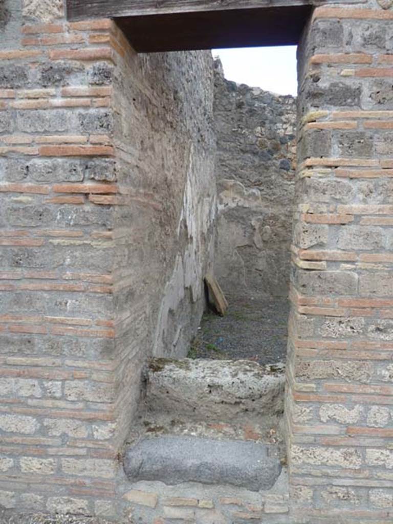 I.21.2 Pompeii. September 2015. Doorway with two stone steps, and wooden stairs that would have led to an upper floor.