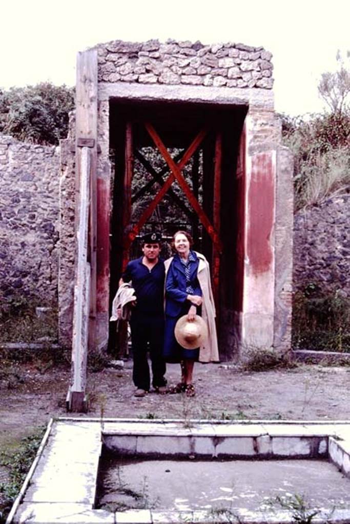 II.3.3 Pompeii, 1982 or 1983. Looking north across impluvium to Wilhelmina and custodian near entrance doorway.  
Source: The Wilhelmina and Stanley A. Jashemski archive in the University of Maryland Library, Special Collections (See collection page) and made available under the Creative Commons Attribution-Non Commercial License v.4. See Licence and use details. J80f0459
