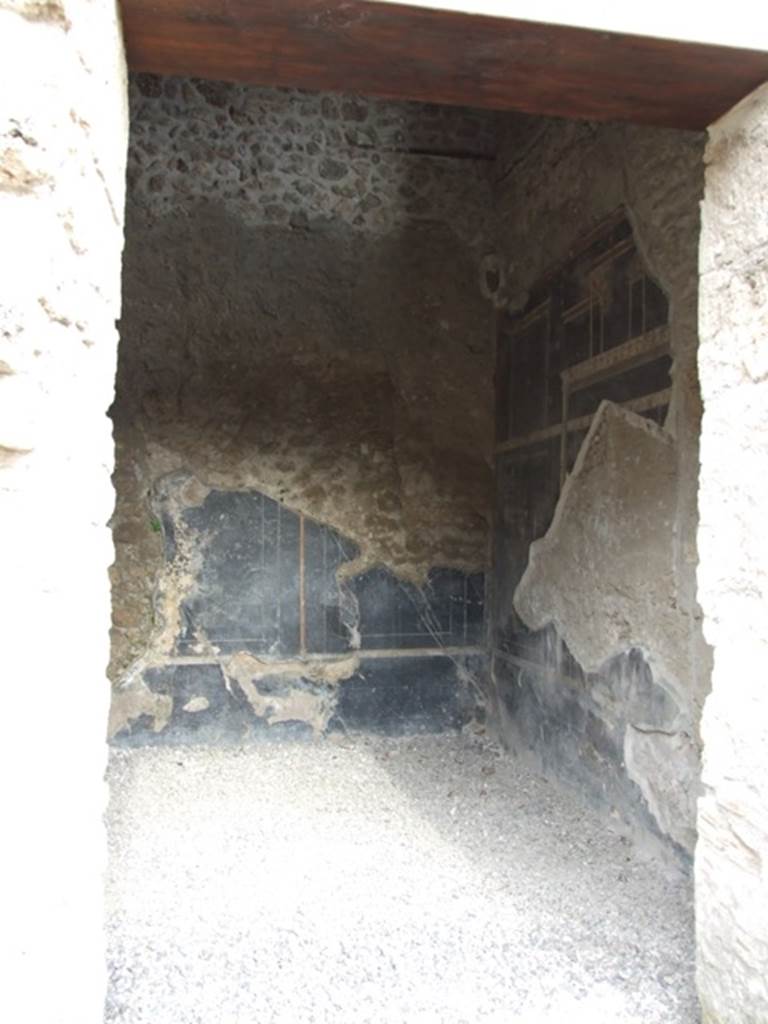 III.2.1 Pompeii. March 2009. 
Doorway to room 7, from room 6, looking east along south wall towards south-east corner.
The south wall must have been affected by the 1943 bombing.
