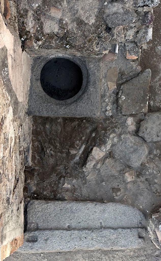 V.1.3 Pompeii. 2010.
Room “d”, west side, looking down onto doorway threshold and with cistern mouth. 
Photo by Hans Thorwid.
Photo and words courtesy of the Swedish Pompeii Project.
