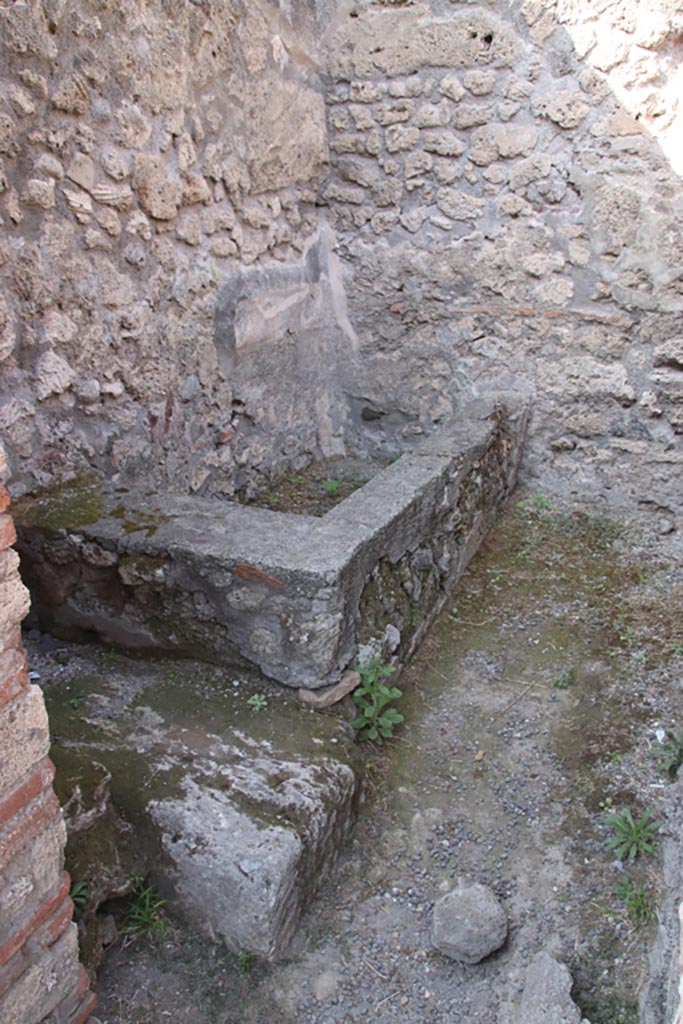 V.1.4 Pompeii. October 2023. 
Looking through doorway of rear room towards water basin. Photo courtesy of Klaus Heese.
