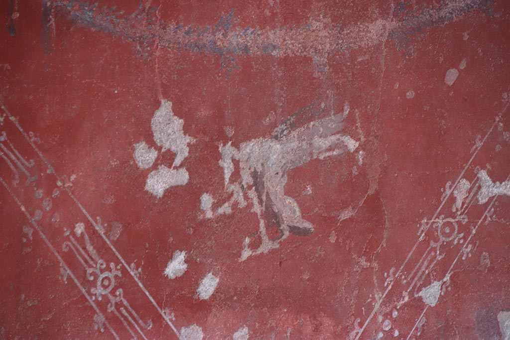 V.2.i Pompeii. October 2024. Tablinum 7, detail of painted zoccolo on red central panel of lower west wall. Photo courtesy of Klaus Heese.