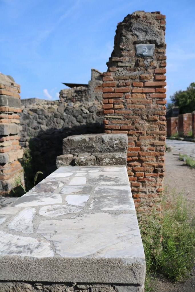 VI.1.2 Pompeii. December 2018. 
South side of entrance doorway, counter and shelving. Photo courtesy of Aude Durand.
