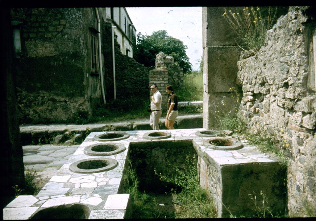 VI.2.1 Pompeii. Looking from rear of counter onto Via Consolare.
Photographed 1970-79 by Günther Einhorn, picture courtesy of his son Ralf Einhorn.
