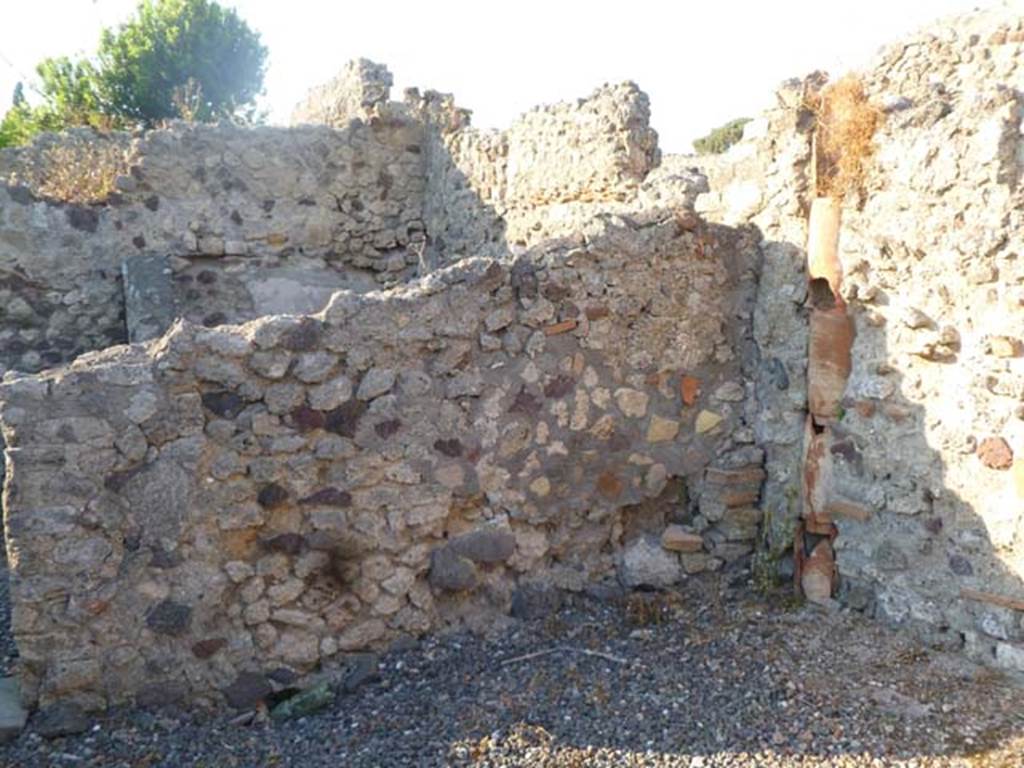 VI.5.9 Pompeii. May 2011. North-east corner of room on south side next to kitchen area, with down-pipe from above.