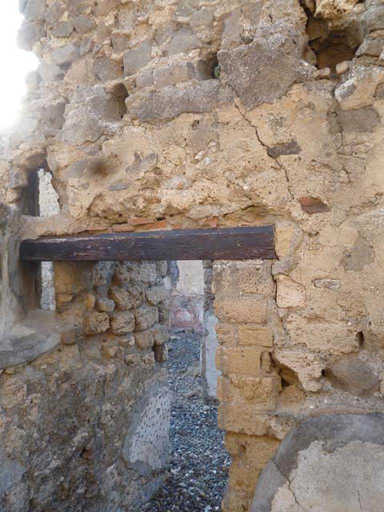 VI.7.1 Pompeii. May 2011. Doorway in north wall of small room or storeroom with remains of two vents.
